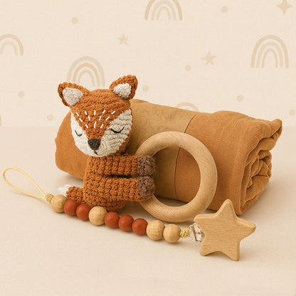 Baby comfort item set with fox plush toy, wooden ring, and star-shaped teether on a beige background.