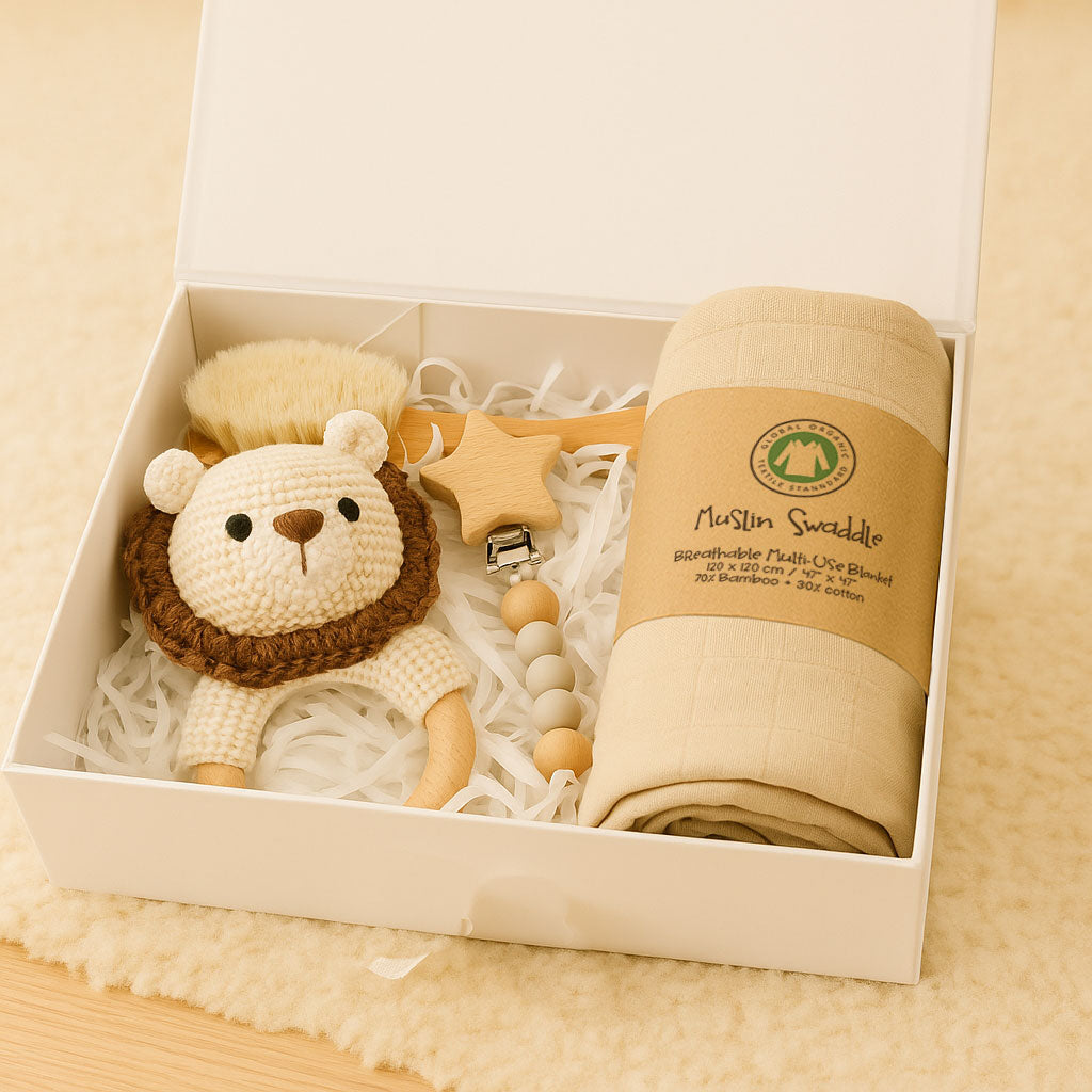 Baby gift set with lion-shaped rattle, teether, and swaddle blanket in a box.