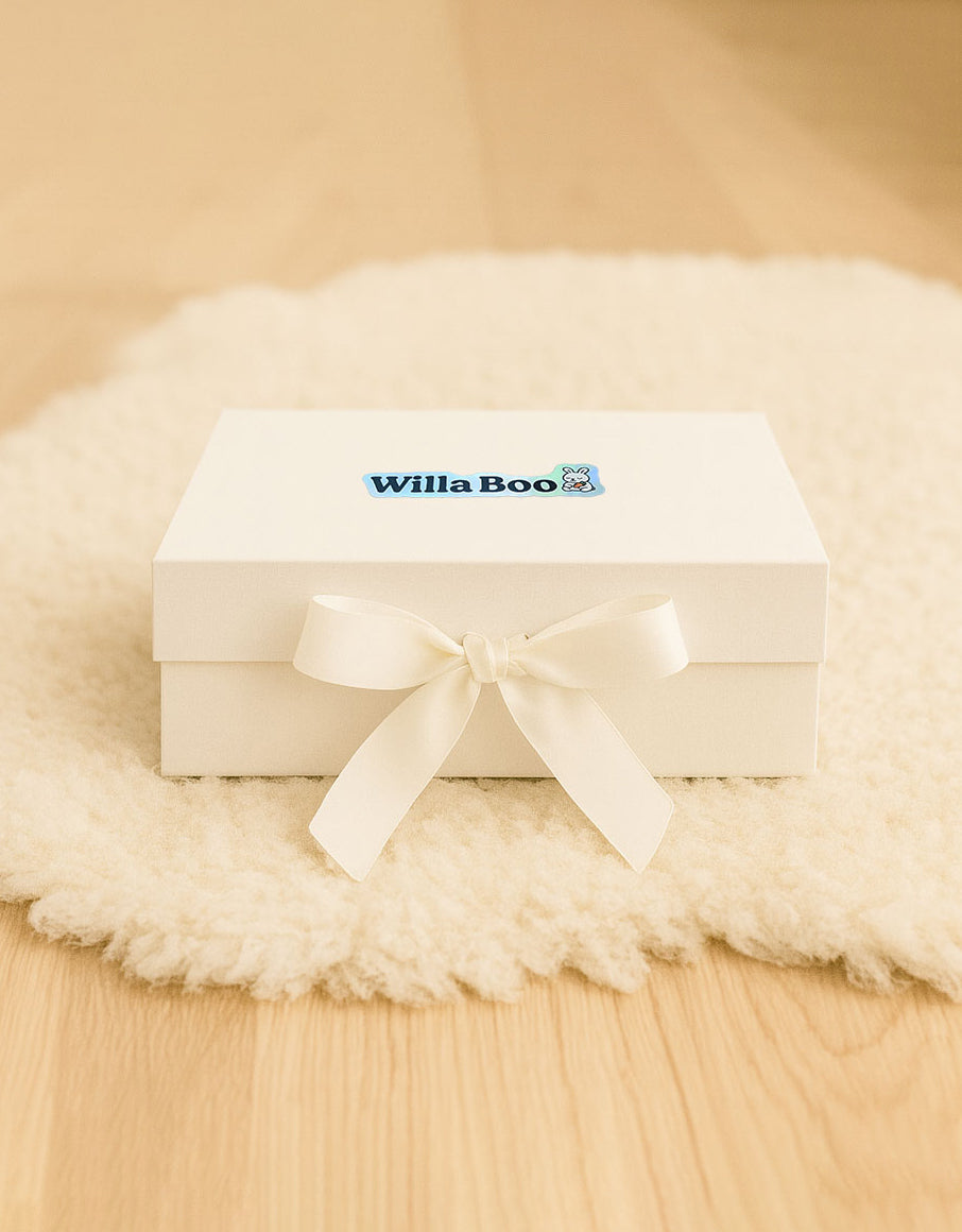 White gift box with a ribbon on a beige surface, featuring the 'Willa Boo' brand.