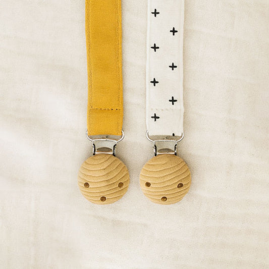Two dummy catchers in yellow and white straps on a beige background